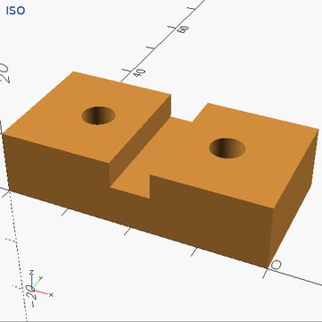 A block with two round holes and a slot across the top.